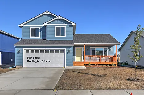 A blue house with a white door and garage.