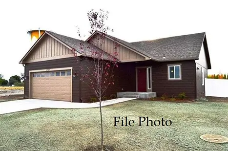 A house with brown siding and red door.