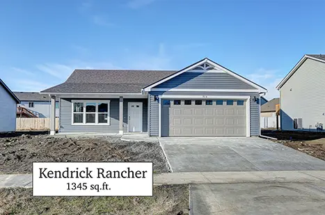 A house with a garage and driveway in front of it.