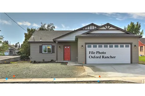 A house with a red door and garage.