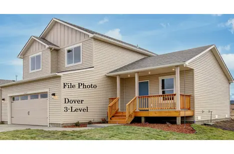 A house with three levels and a porch.