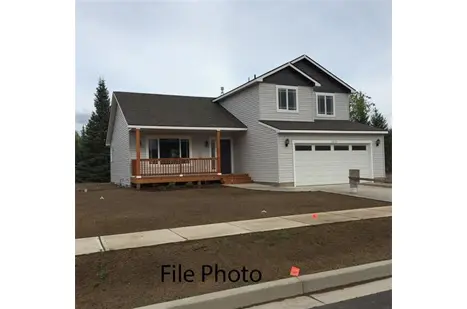 A house with a driveway and garage in front of it.