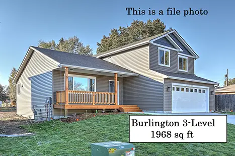 A house with a yard and a sign that says " this is a file photo ".