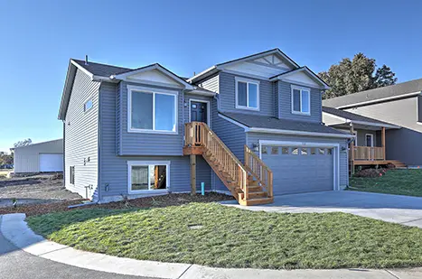 A house with stairs leading to the front door.